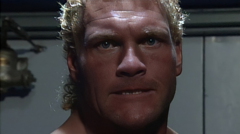 A closeup of wrestler Sid Vicious' face looking menacing
