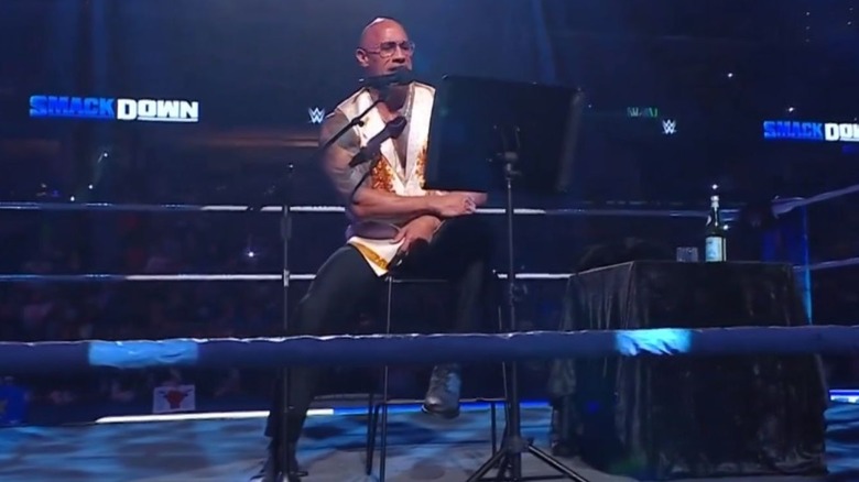 The Rock sits in the middle of the ring for a "Rock Concert" during an episode of "WWE SmackDown" in Memphis.