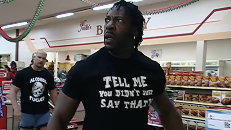 Booker T during the Supermarket Brawl with Steve Austin in the background