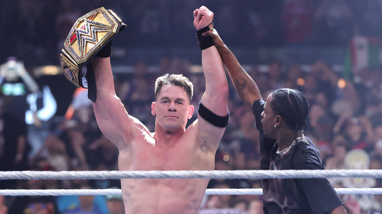 John Cena (L) celebrates with rapper Travis Scott after defeating Cody Rhodes for the Undisputed WWE Championship during WrestleMania 41 at Allegiant Stadium on April 20, 2025 in Las Vegas, Nevada.