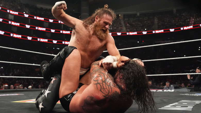 Sami Zayn delivering mounted punches to Karrion Kross on "WWE Raw"