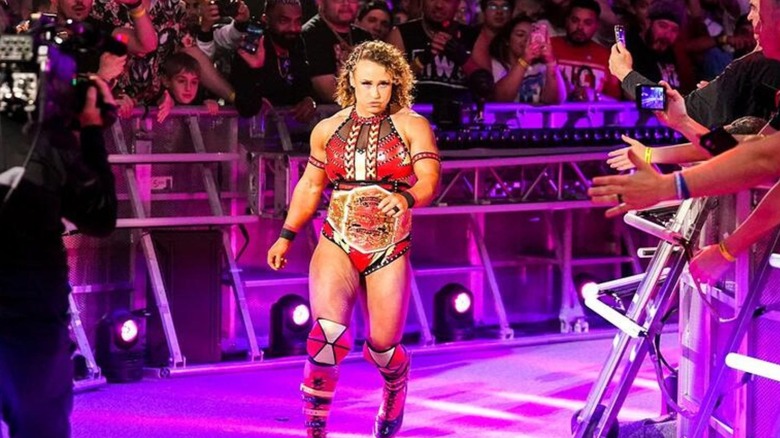 Jordynne Grace heads down the ramp to the WWE ring at the Royal Rumble wearing the Knockouts Championship.