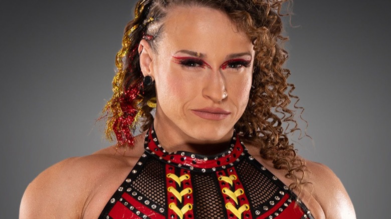 Jordynne Grace poses for the camera in a backstage photo wearing the Knockouts Championship.