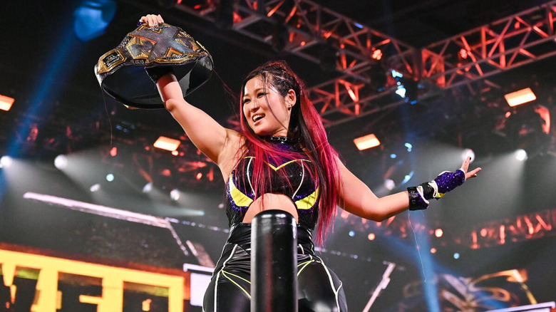 Io Shirai holds up the NXT Women's Championship after defeating Candice LeRae.