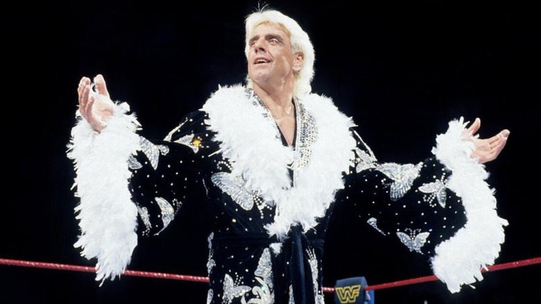 Ric Flair poses in one of his glamorous robes in the middle of the ring before a match in the then-WWF.