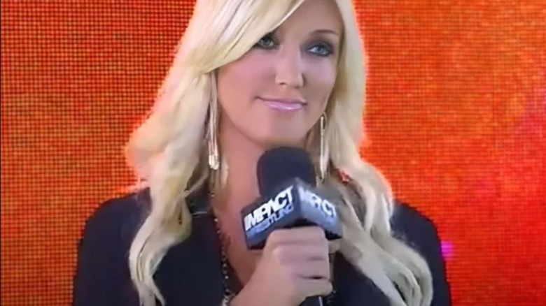 Brooke Hogan cuts a promo from the stage while looking down the ramp to the ring during an episode of "TNA Impact."