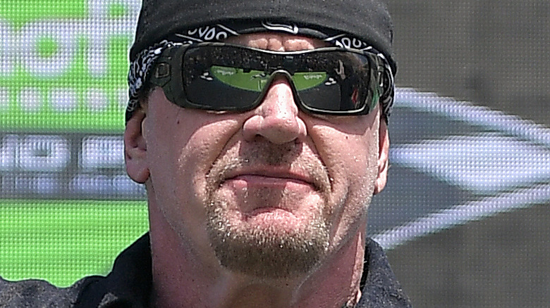 The Undertaker smiling with sunglasses on