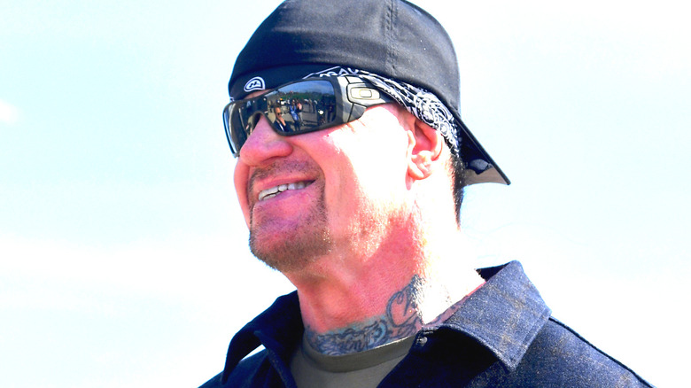 The Undertaker smiling in shades