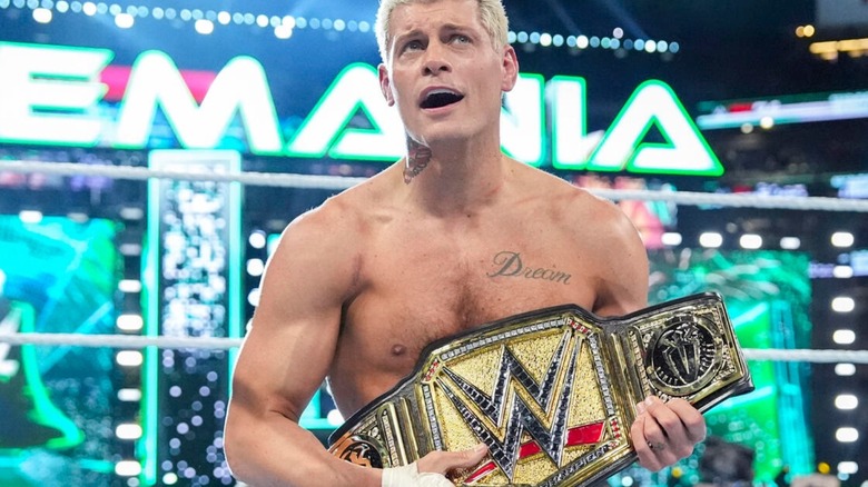 Cody Rhodes holds the Undisputed WWE Championship in the middle of the ring after defeating Roman Reigns at WrestleMania 40.