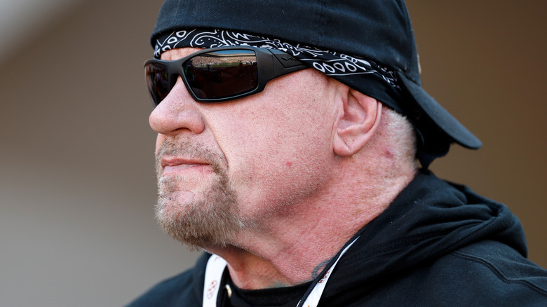 the undertaker wearing a backwards cap