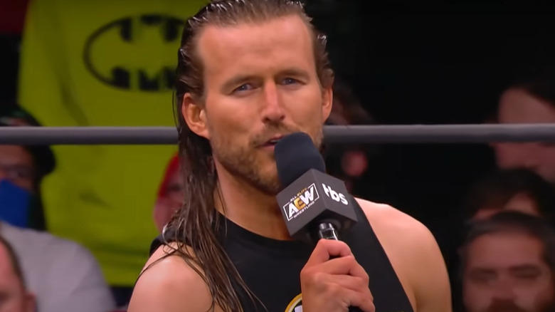 Adam Cole speaking into microphone