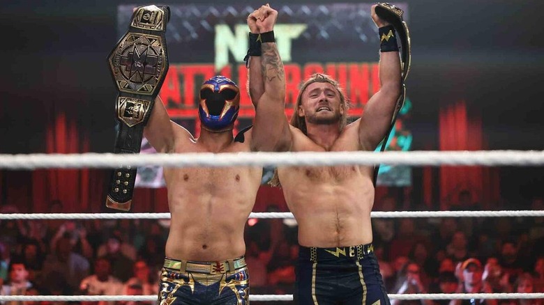 Axiom and Nathan Frazer hold up the NXT Tag Team Championships after defeating The Good Brothers at NXT Battleground.