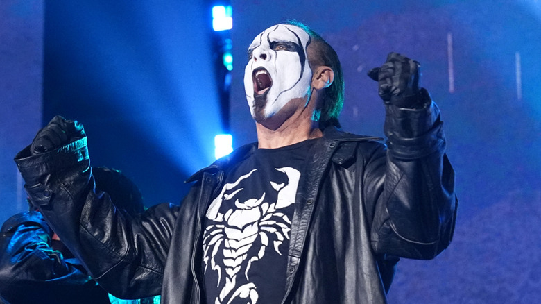 Sting poses on the stage with his sons ahead of his final match at AEW Revolution in March 2024.