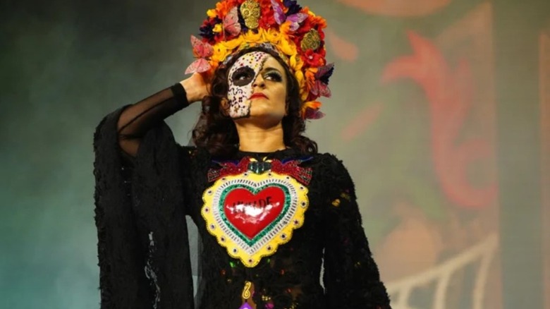 Thunder Rosa heads down to the ring in a traditional head dress before a match in AEW.