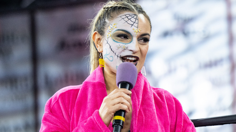 Thunder Rosa holding a microphone