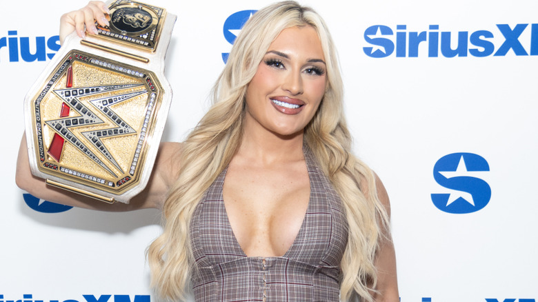 Tiffany Stratton holding up the WWE Women's Championship