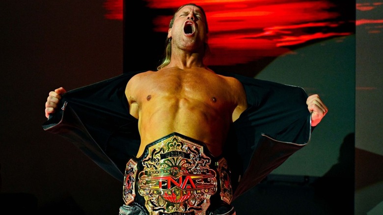 TNA World Champion Nic Nemeth poses on the stage, showing off the title around his waist, on an episode of 