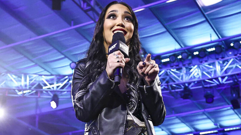 Roxanne Perez talking into a microphone