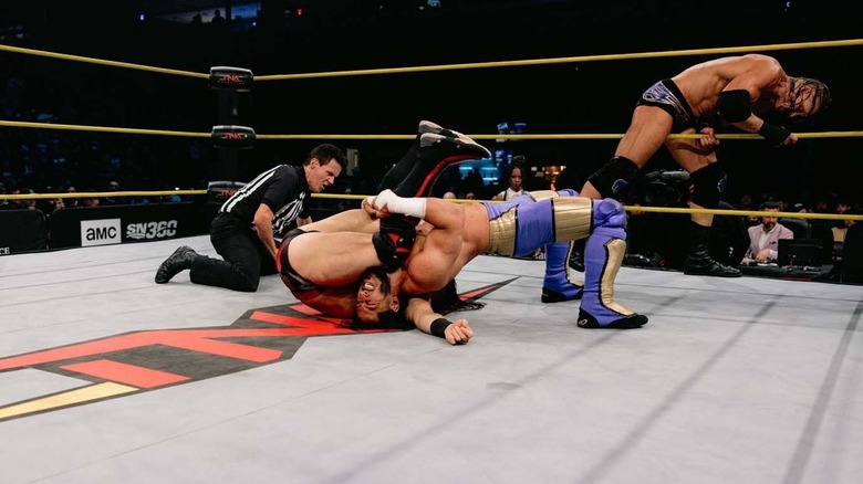 Mustafa Ali attempting to pin someone