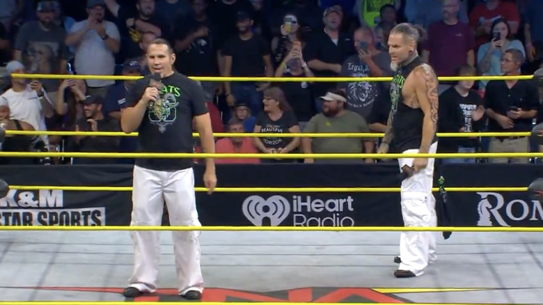 Matt Hardy and Jeff Hardy both standing inside the ring