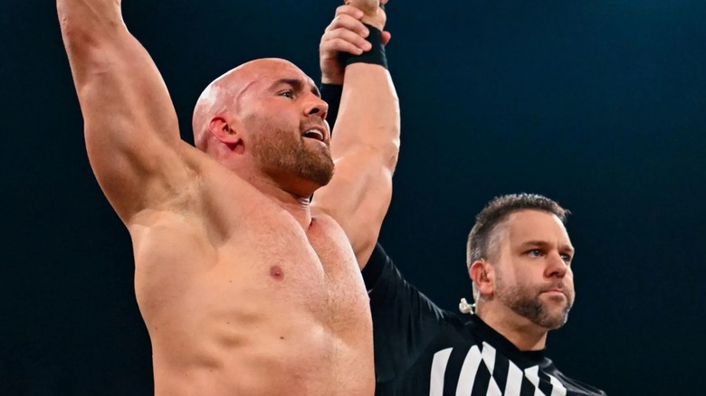 Fabian Aichner gets his hands raised by the referee after winning his match