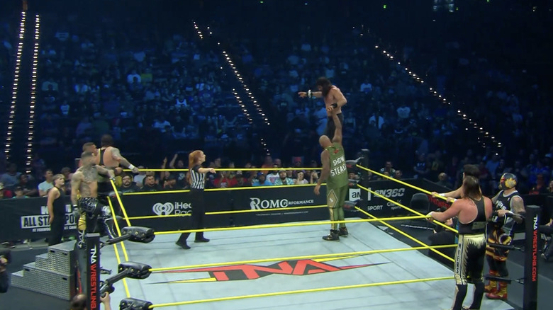 All eight men inside and around the ring