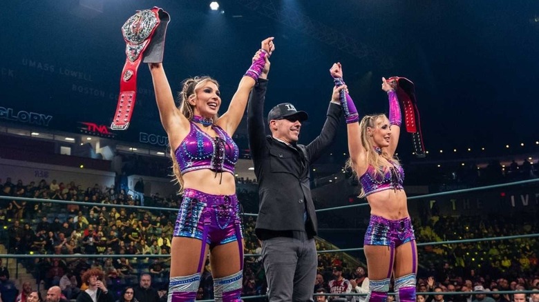 Jessie McKay and Cassie Lee of The IInspiration hold up their TNA Knockouts World Tag Team Championships.