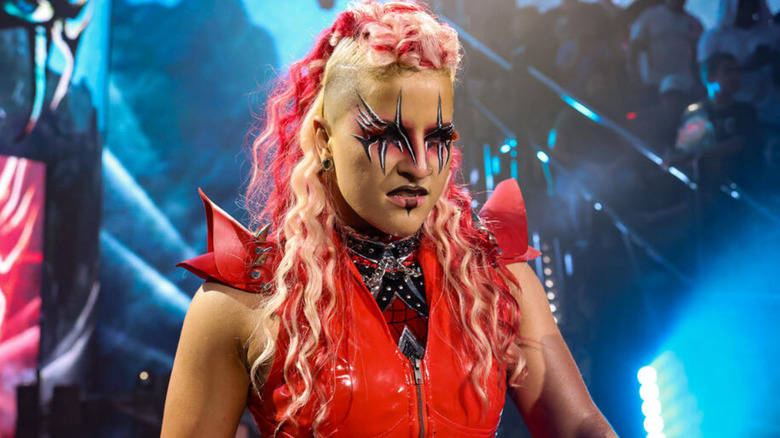 Zaria is wearing a red ring vest