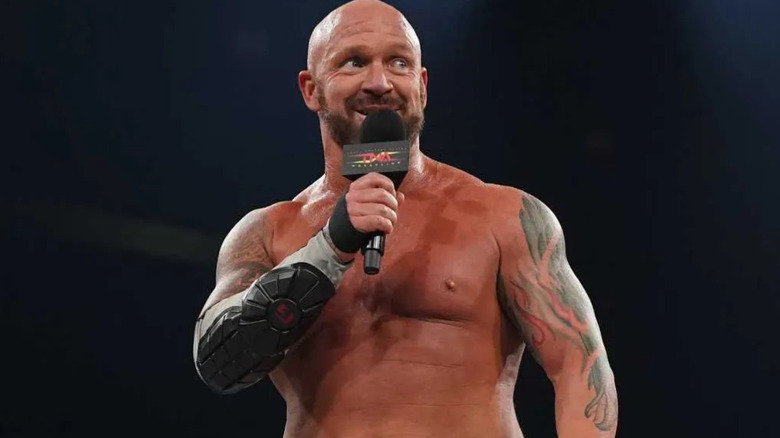 Eric Young holding a microphone