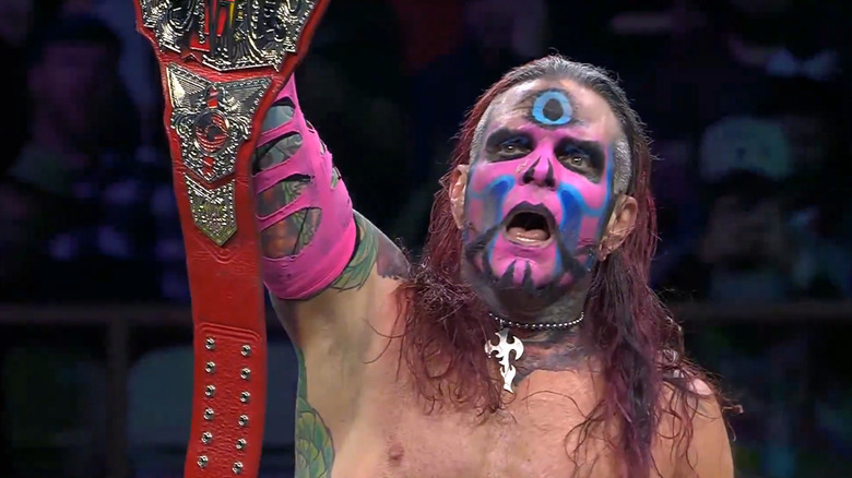 TNA wreslter Jeff Hardy holds the tag team world championship belt aloft