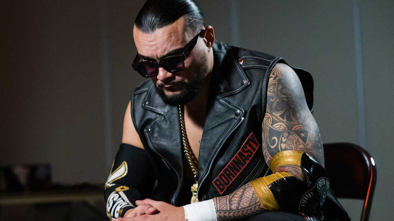 TNA world champion Mike Santana sits on a folding chair