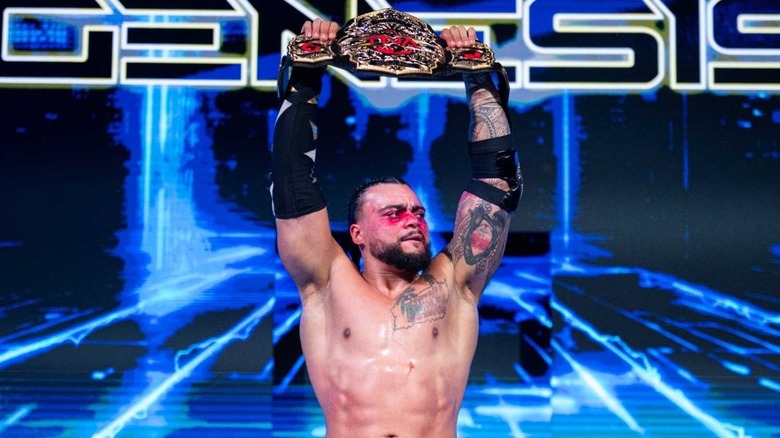 Mike Santana holds up his TNA World Championship at Genesis.