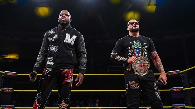 Moose and Mike Santana standing in a TNA ring