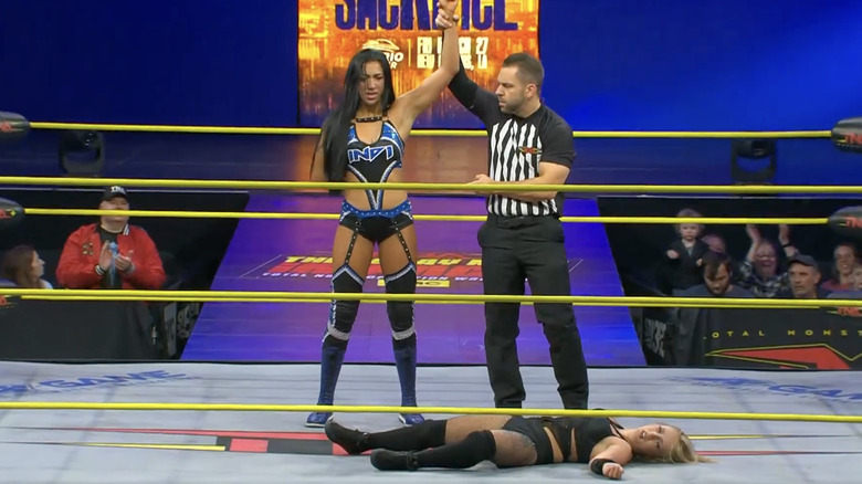 Indi Hartwell standing over Heather