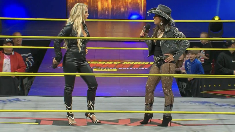 Ash and James staring one another down in the ring