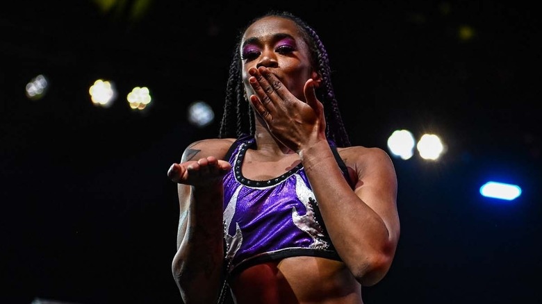Jada Stone blowing a kiss while standing on a turnbuckle