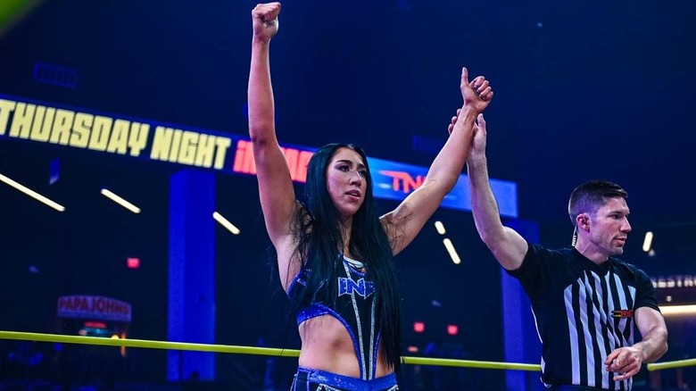 Indi Hartwell having her arm raised after a win on TNA Impact