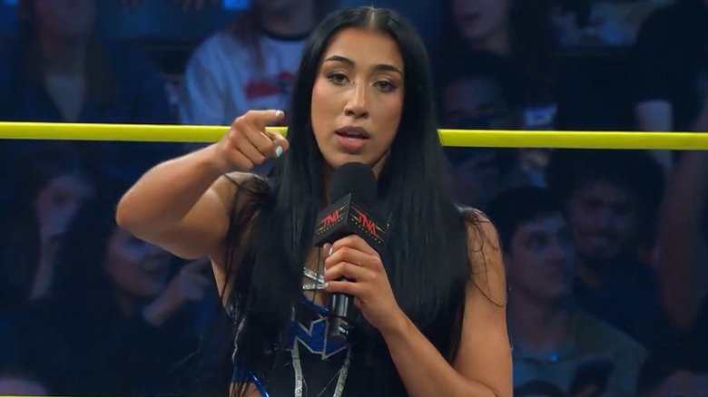 Indi Hartwell holding a microphone