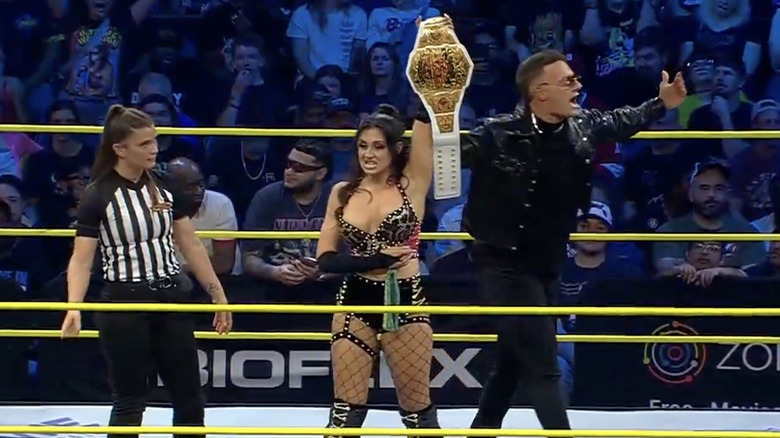 Grace holding up the TNA Knockouts World Championship belt