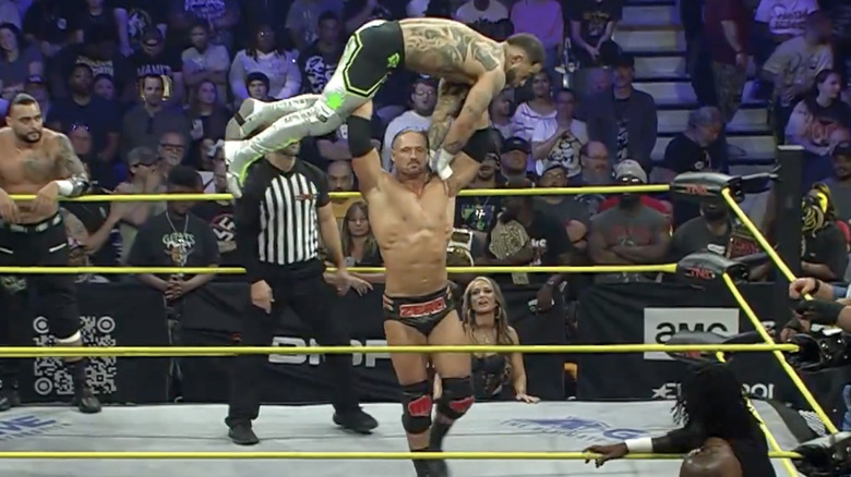 Agent 0 with Trey Miguel raised above his head