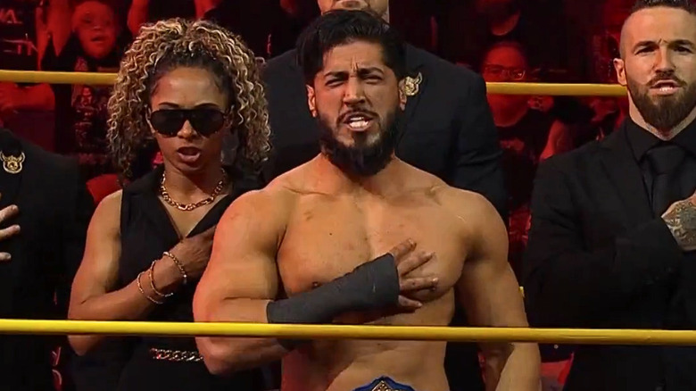 Mustafa Ali and Order 4 putting their hands over their hearts