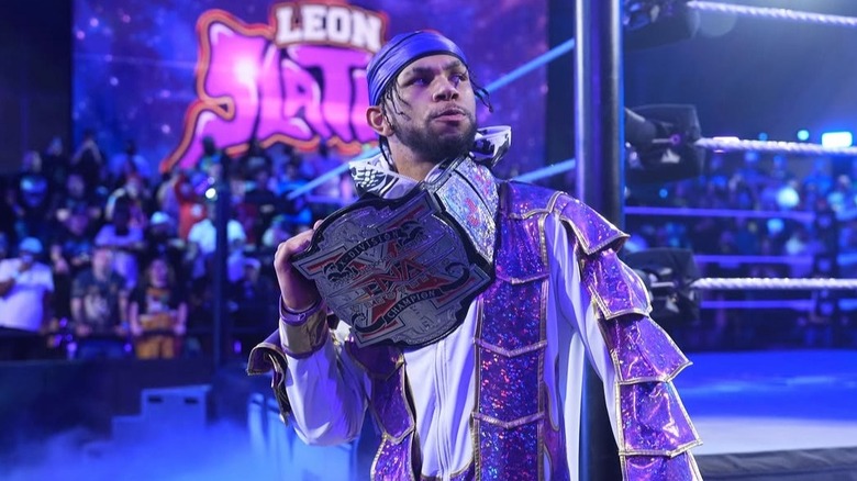 Leon Slater greets the fans with the former X-Division Championship wrapped around his neck