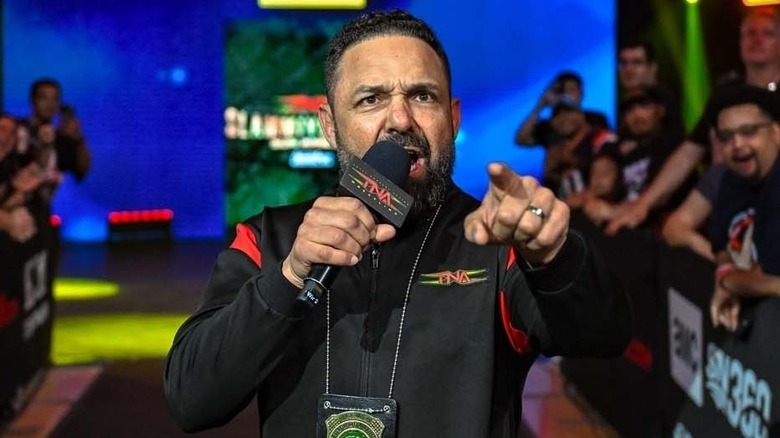 Santino Marella shouting into a TNA mic and pointing