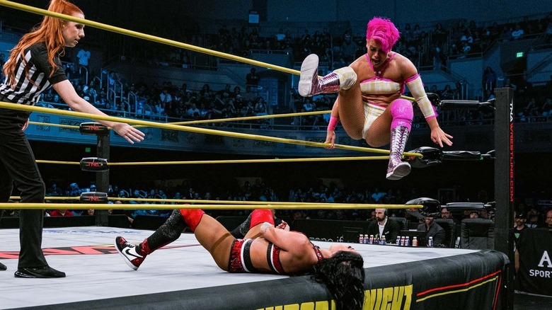 Harley Hudson tries to connect a brutal leg drop on Tessa Blanchard who is laying on the ring apron