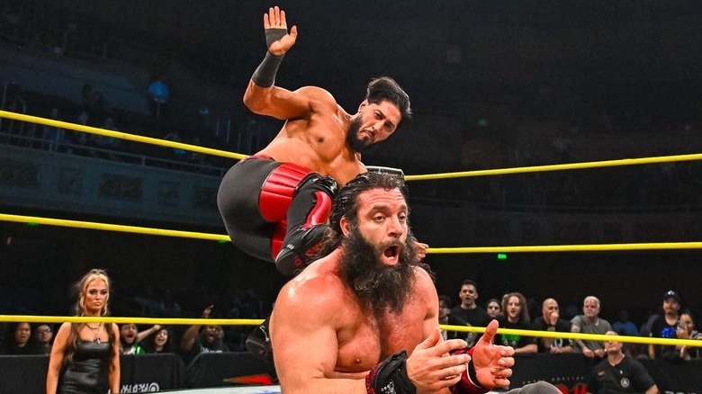 Mustafa Ali dropkicking Elijah