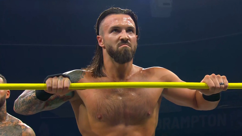 Jason Hotch looking angry while holding onto the ring ropes