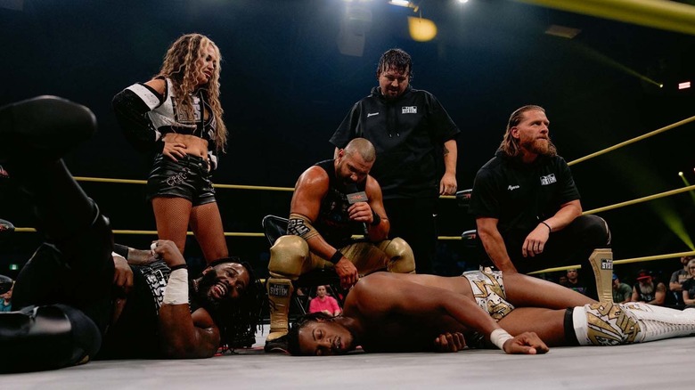 The System standing over Ricky Sosa on TNA Impact