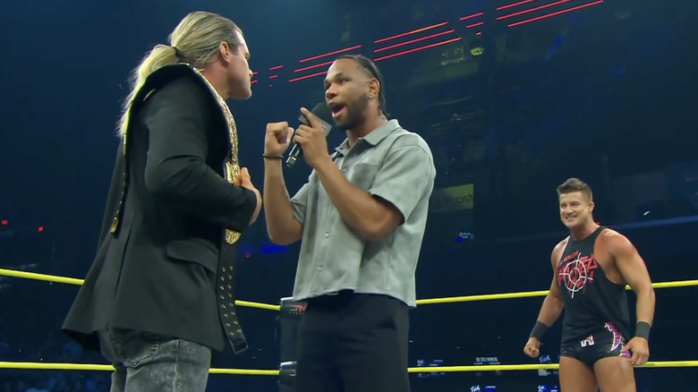 Slater talking to Nic as Ryan is standing behind him