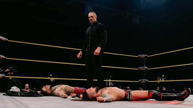Special Agent Zero standing over Jason Hotch and Trey Miguel