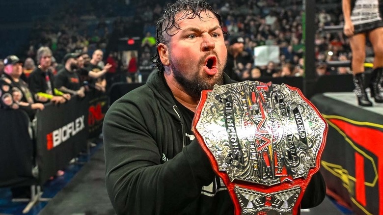 Bear Bronson posing with his TNA tag title